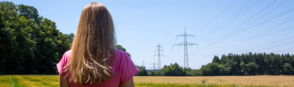 Frau schaut Richtung Stromleitung Frau schaut Richtung Stromleitung